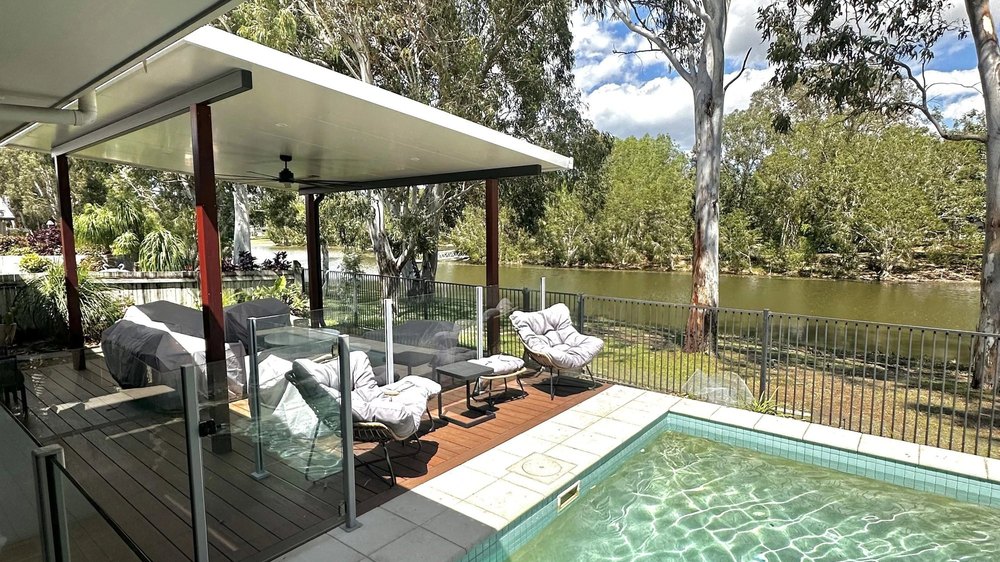 Poolside deck and entertaining area looking out over the water