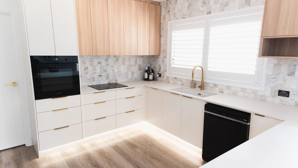Kitchen in Tasmanian Oak with a stone splashback and brass tapware
